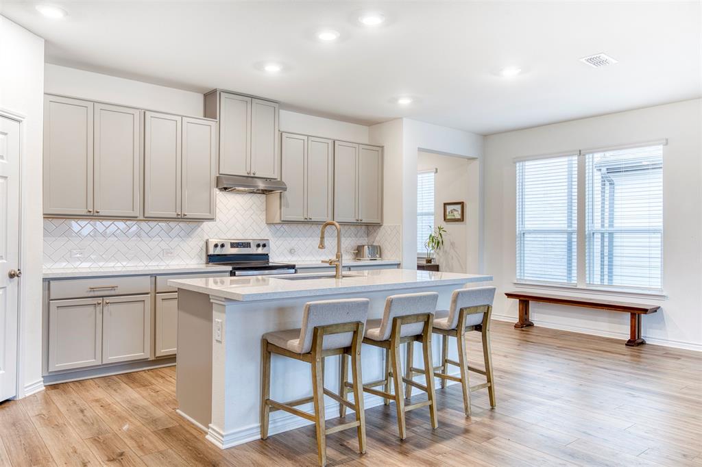 2513 Wayne Avenue Aubrey, TX 76227 - Photo 14 of 27 a kitchen with a table and chairs in it