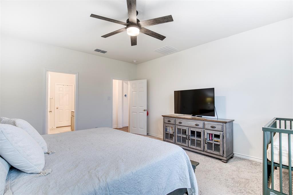 2513 Wayne Avenue Aubrey, TX 76227 - Photo 17 of 27 a bedroom with bed and a flat screen tv