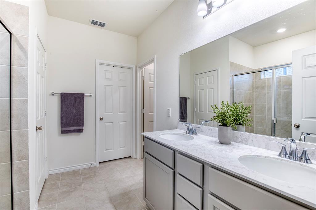 2513 Wayne Avenue Aubrey, TX 76227 - Photo 18 of 27 a bathroom with a granite countertop sink and mirror