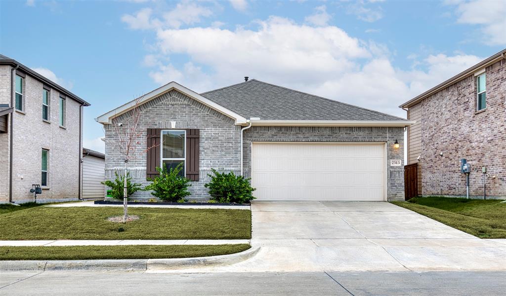 2513 Wayne Avenue Aubrey, TX 76227 - Photo 2 of 27 a front view of a house with a garden