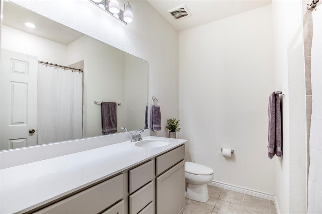 2513 Wayne Avenue Aubrey, TX 76227 - Photo 23 of 27 a bathroom with a double vanity sink toilet and mirror