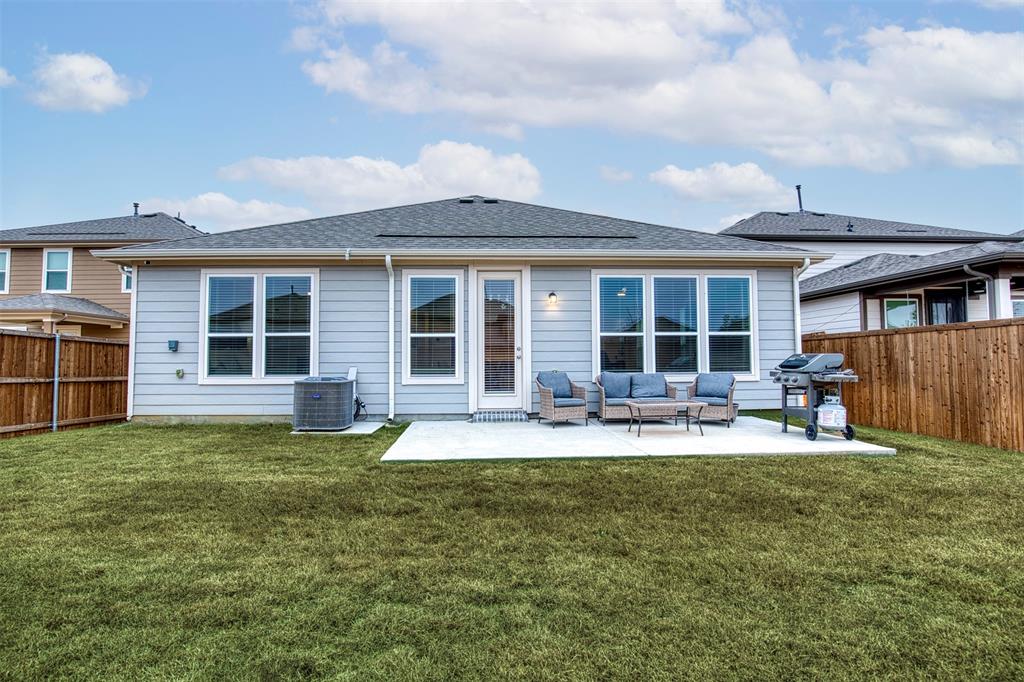 2513 Wayne Avenue Aubrey, TX 76227 - Photo 25 of 27 a house that has a big yard with table and chairs in front of house