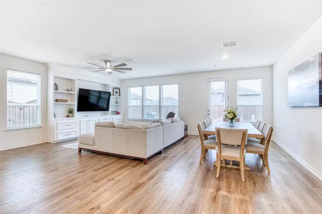 a living room with furniture and view of kitchen