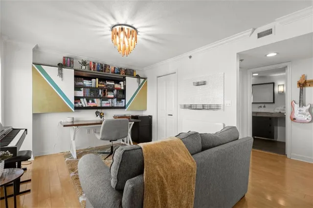 a living room with furniture fireplace and a large window