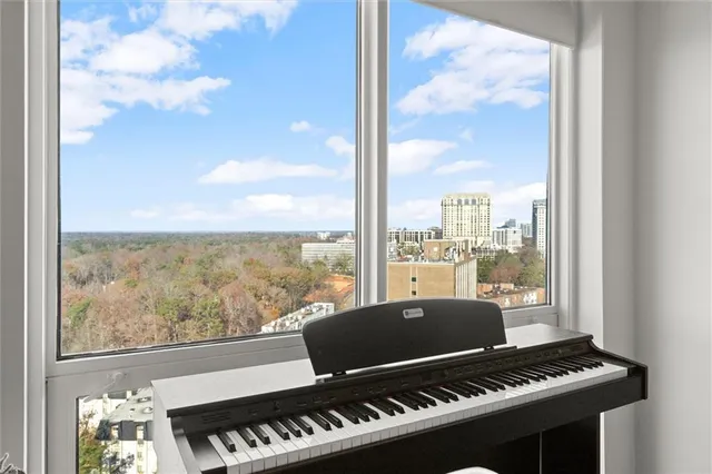 a bathroom with a granite countertop sink mirror vanity and toilet