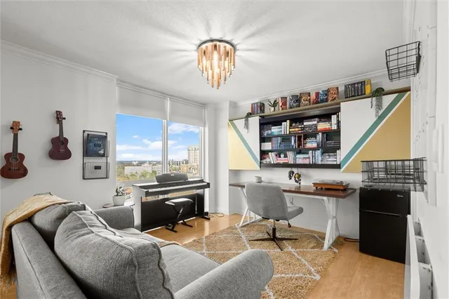 a bedroom with a bed and a tv on the dresser