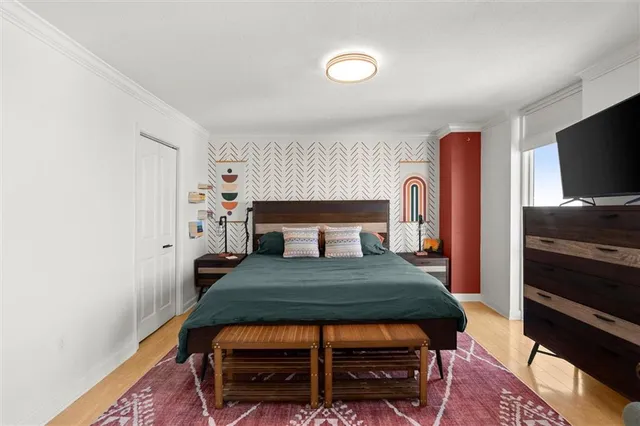 a bathroom with a granite countertop sink a toilet a mirror and shower