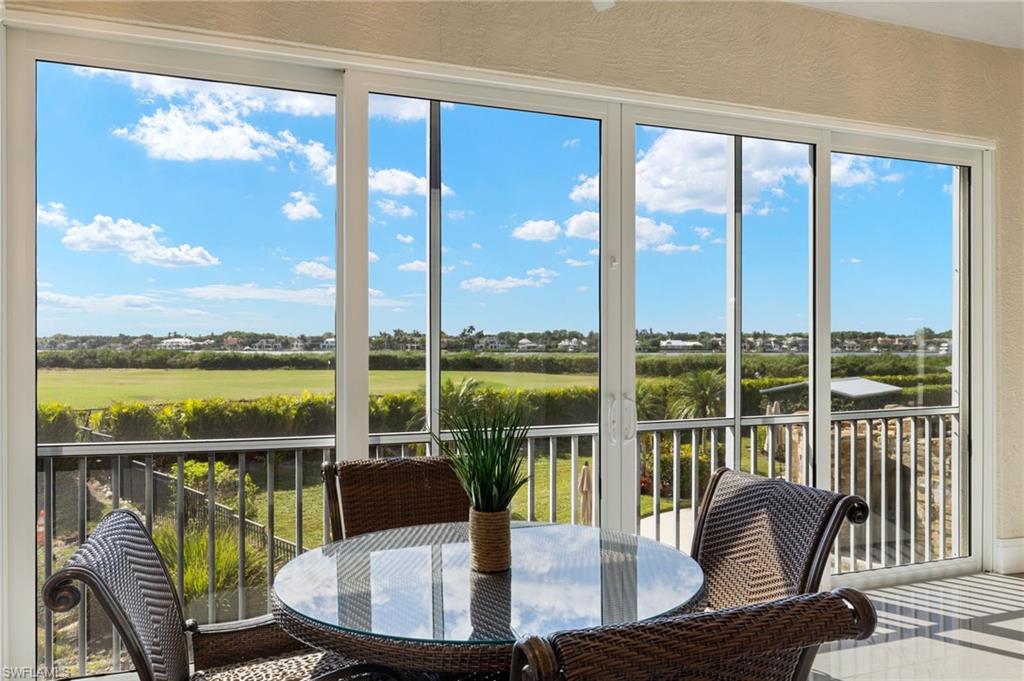 1620 Star Point Lane, Unit 1102 Naples, FL 34112 - Photo 1 of 50 Sunroom / solarium featuring view of the bay and golf course