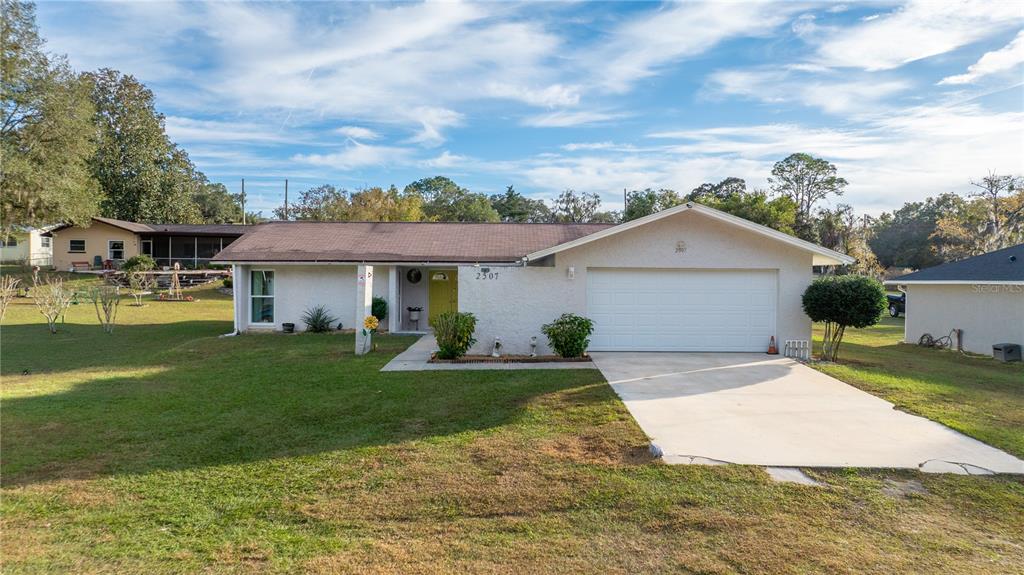 2507 Bluegrass Street Inverness, FL 34453 - Photo 1 of 30 a view of a house with a yard and sitting area