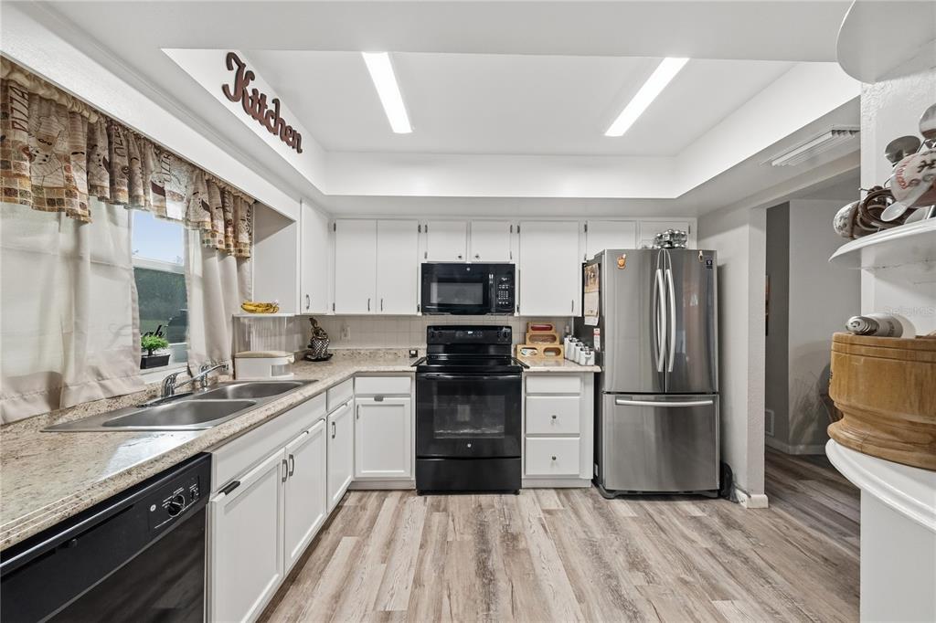 2507 Bluegrass Street Inverness, FL 34453 - Photo 11 of 30 a kitchen with a sink stainless steel appliances and cabinets