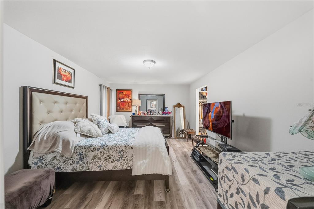 2507 Bluegrass Street Inverness, FL 34453 - Photo 14 of 30 a bedroom with a bed and wooden floor