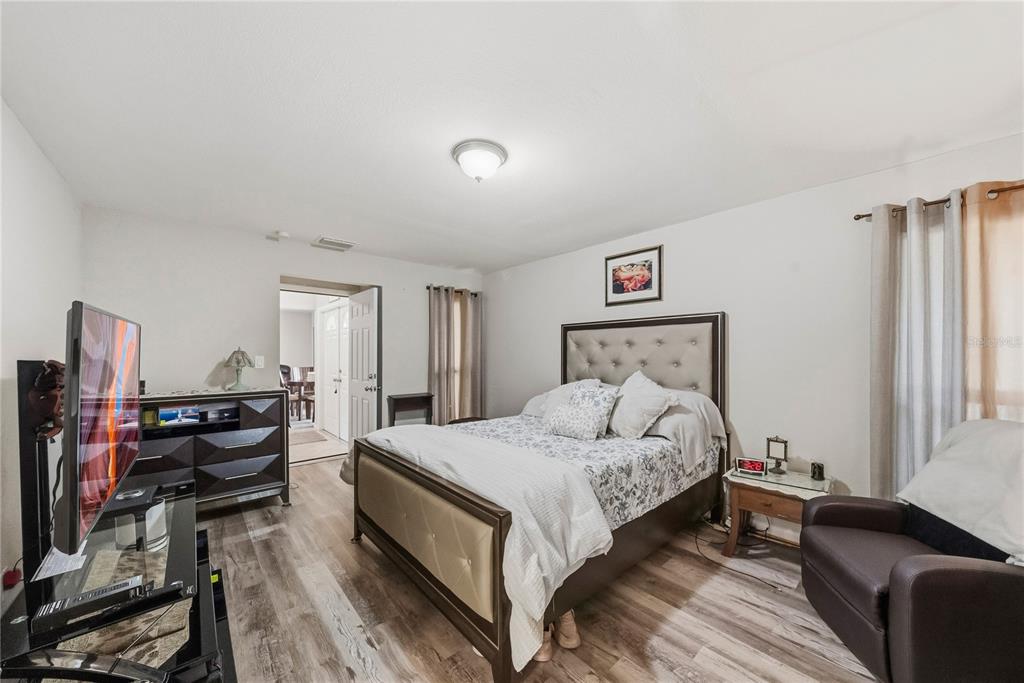 2507 Bluegrass Street Inverness, FL 34453 - Photo 16 of 30 a bedroom with a bed and wooden floor