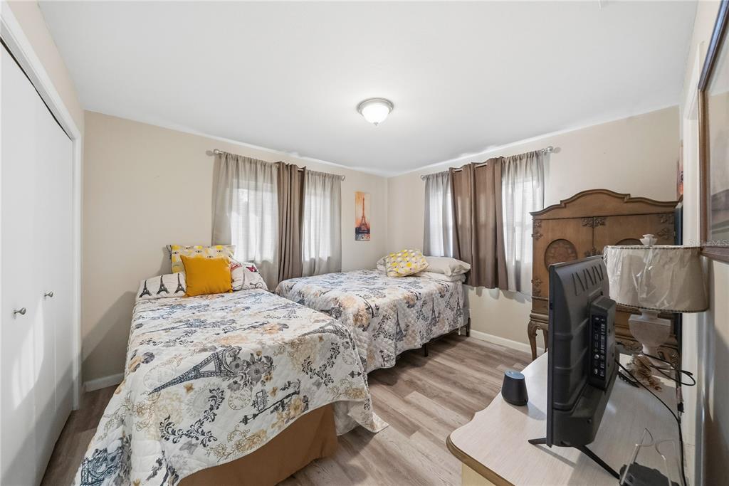 2507 Bluegrass Street Inverness, FL 34453 - Photo 21 of 30 a bedroom with a bed and wooden floor