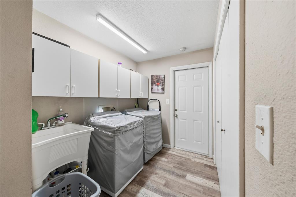 2507 Bluegrass Street Inverness, FL 34453 - Photo 24 of 30 a room with a sink a washer and dryer