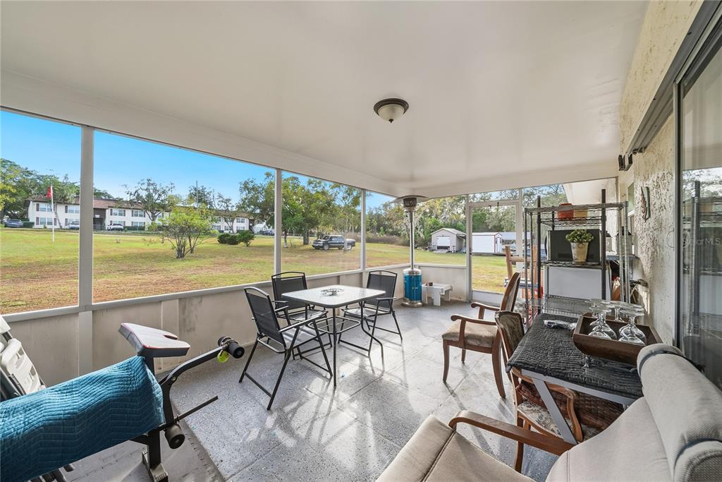 2507 Bluegrass Street Inverness, FL 34453 - Photo 25 of 30 a view of a patio with dining table and chairs