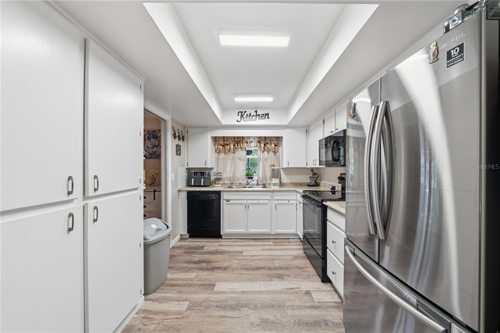 2507 Bluegrass Street Inverness, FL 34453 - Photo 10 of 30 a kitchen with a refrigerator a sink and dishwasher
