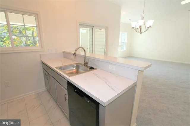a kitchen with a sink cabinets and window