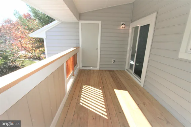 a view of balcony with wooden floor