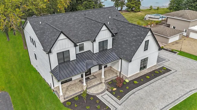 an aerial view of a house with pool table and chairs