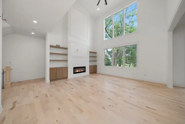a kitchen with granite countertop a sink window and cabinets