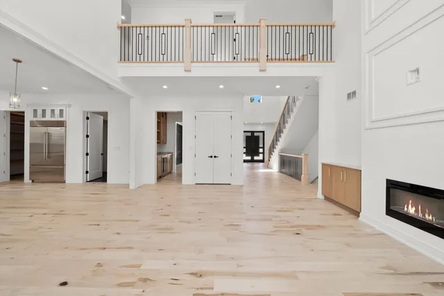 a large kitchen with a lot of counter space and wooden floor