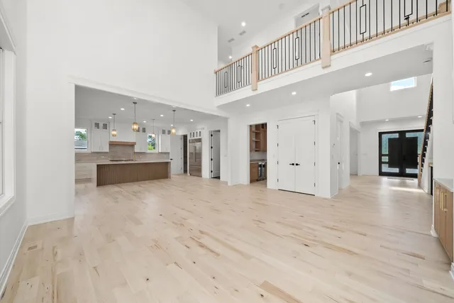 an empty room with ceiling fan and window
