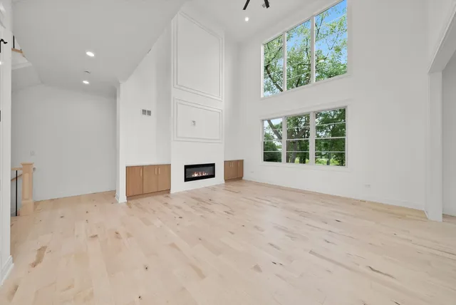 a view of a room with wooden floor and windows