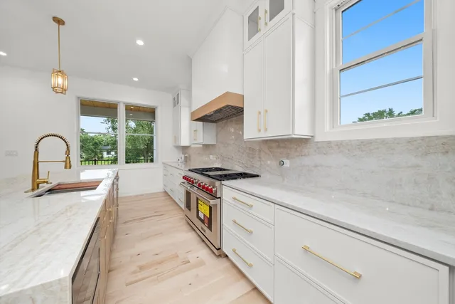 a kitchen with a sink cabinets and a window