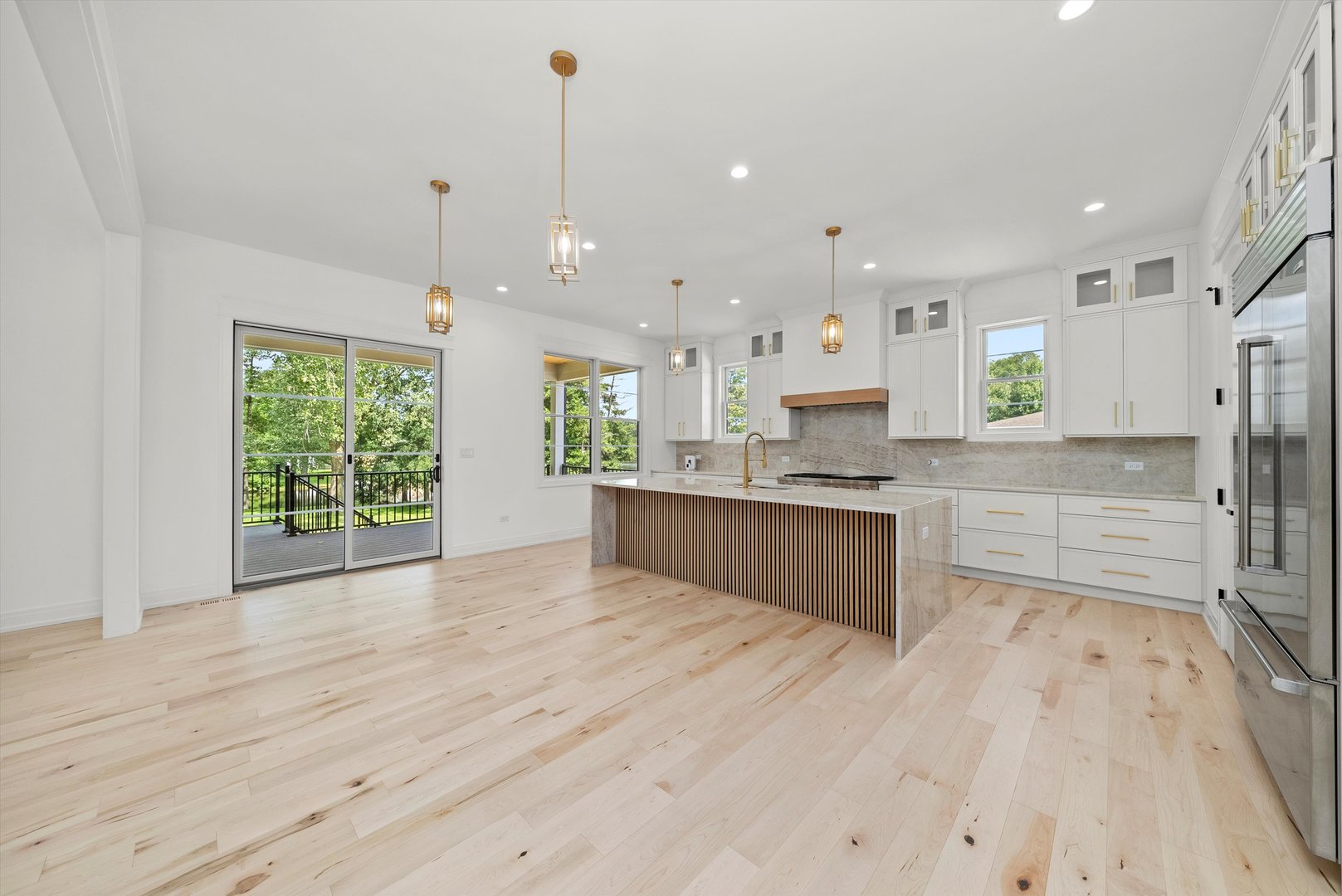 15W670 83rd Street Burr Ridge, IL 60527 - Photo 41 of 108 a large kitchen with kitchen island a stove a refrigerator a sink dishwasher and a fireplace with wooden floor