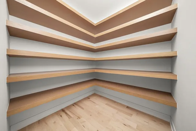 a view of empty room with wooden floor and windows