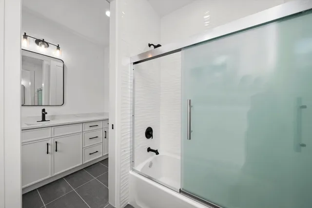 a view of a house with a yard and potted plants