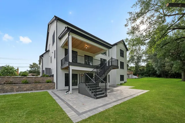 a front view of a house with yard and green space