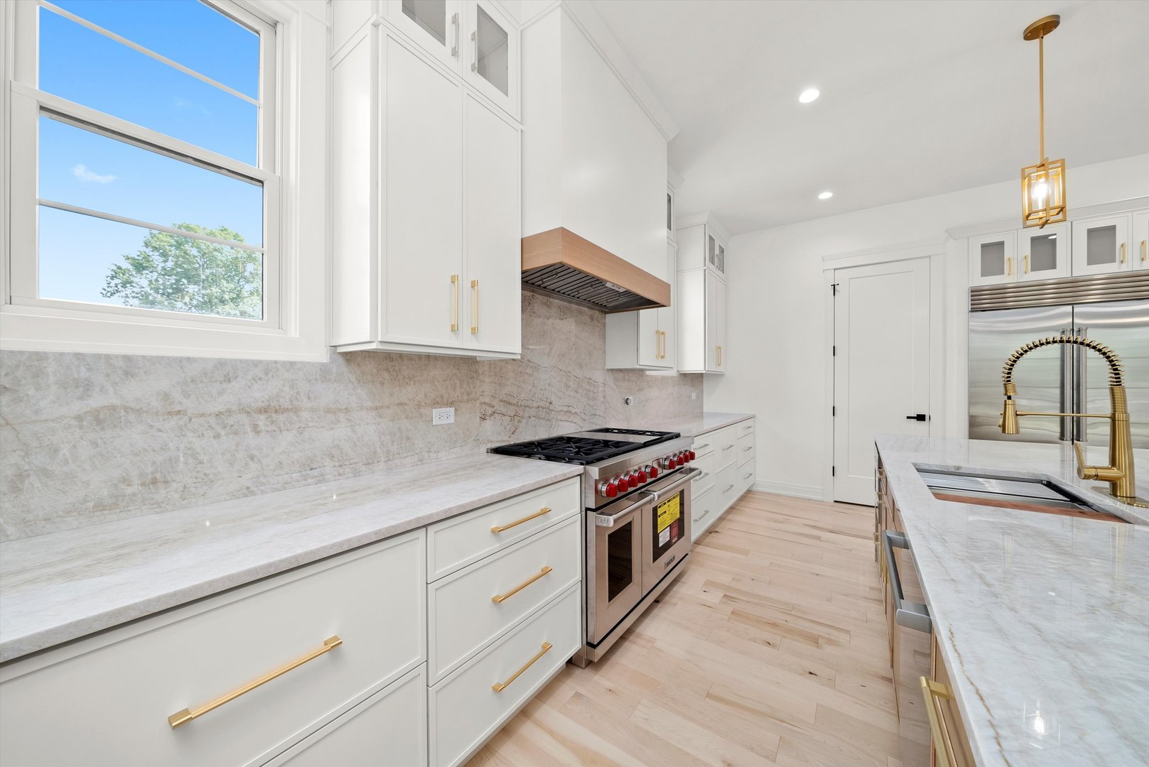 15W670 83rd Street Burr Ridge, IL 60527 - Photo 56 of 108 a kitchen with stainless steel appliances granite countertop a sink a stove and a wooden floors