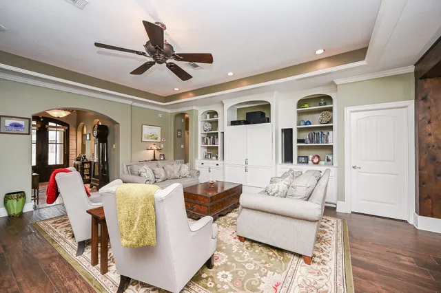 a living room with furniture ceiling fan and a rug