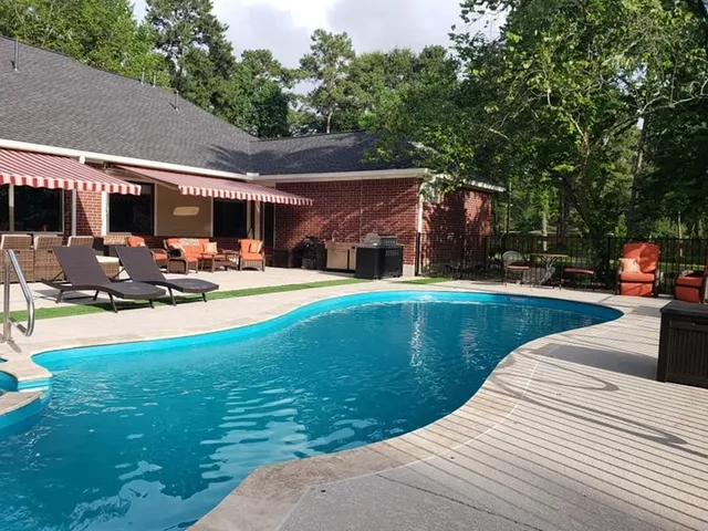 a view of a house with swimming pool and sitting area
