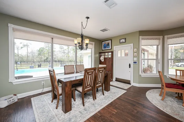 a bedroom with a bed a table and chair