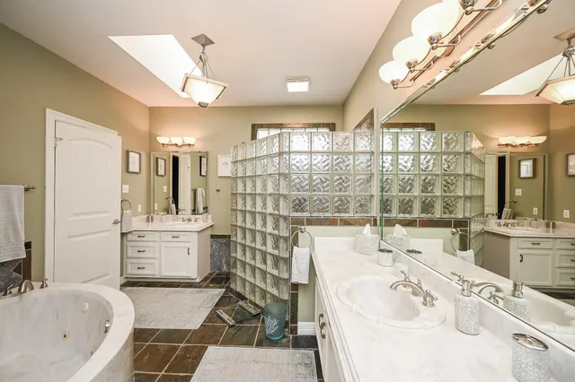 a bathroom with a double vanity sink mirror and