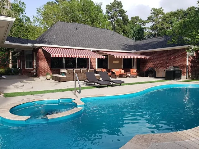 an outdoor space with pool and furniture