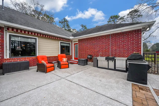 a view of a patio with table and chairs under an umbrella