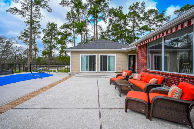 a backyard of a house with barbeque oven and a fire pit