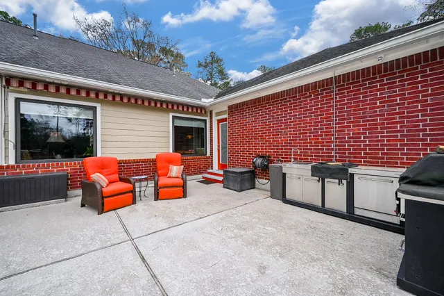 a view of a patio with table and chairs