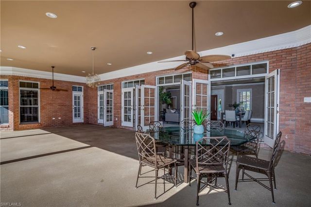 a view of a backyard with potted plants and a bench