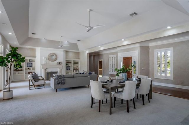 a living room with fireplace furniture and a large window