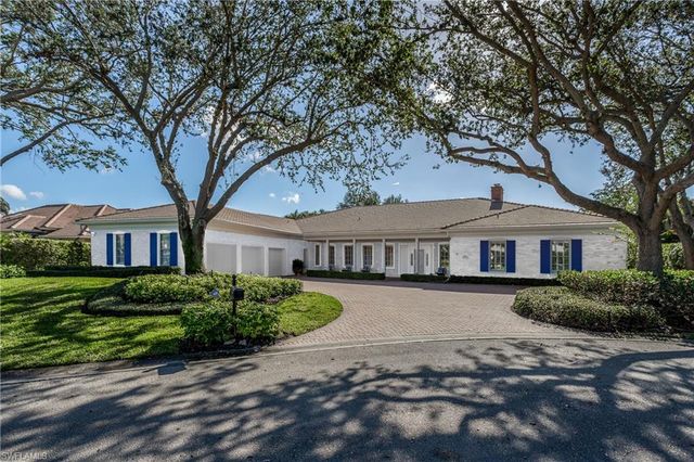 a kitchen with granite countertop kitchen island stainless steel appliances a sink and living room