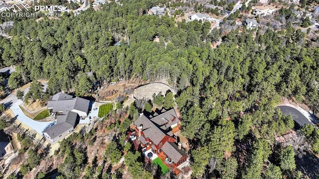 an aerial view of a house with a yard and outdoor seating