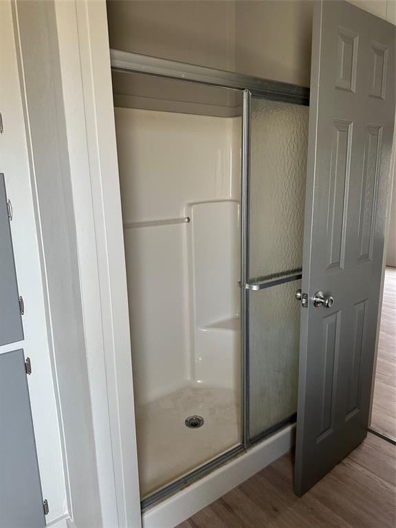 1109 Market Street Tye, TX 79563 - Photo 12 of 20 a bathroom with a glass shower door