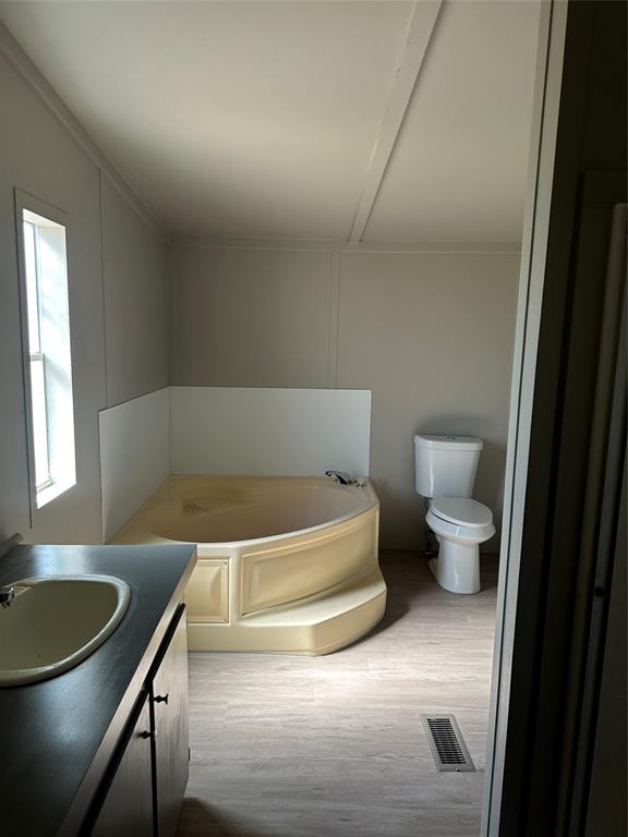 1109 Market Street Tye, TX 79563 - Photo 13 of 20 a bathroom with a bathtub and a toilet