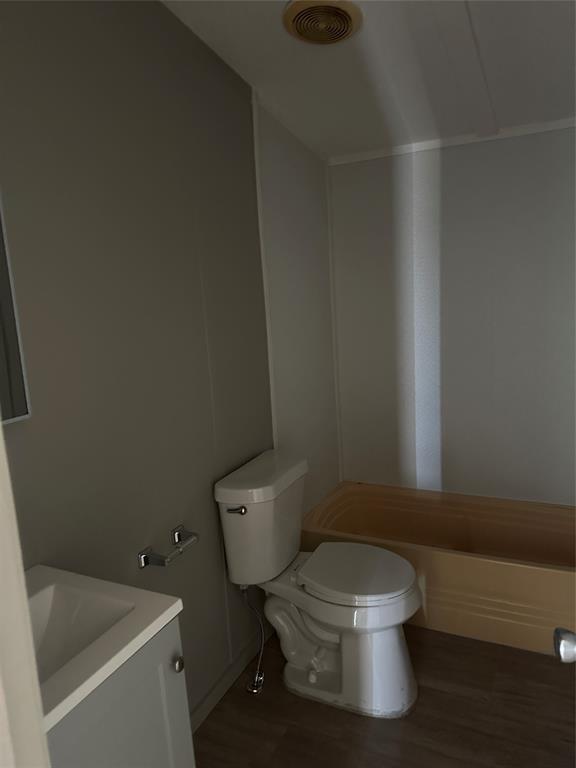 1109 Market Street Tye, TX 79563 - Photo 16 of 20 a white toilet sitting next to a white sink and vanity