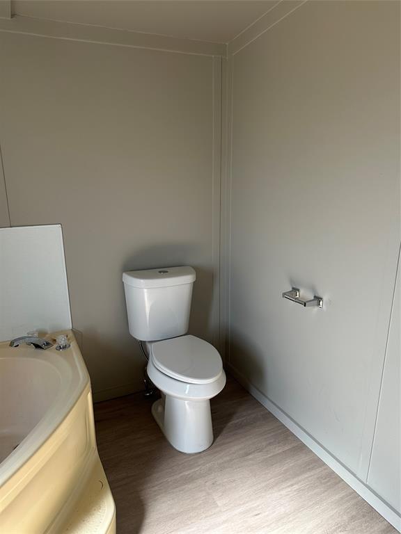 1109 Market Street Tye, TX 79563 - Photo 10 of 20 a white toilet sitting next to a white cabinet