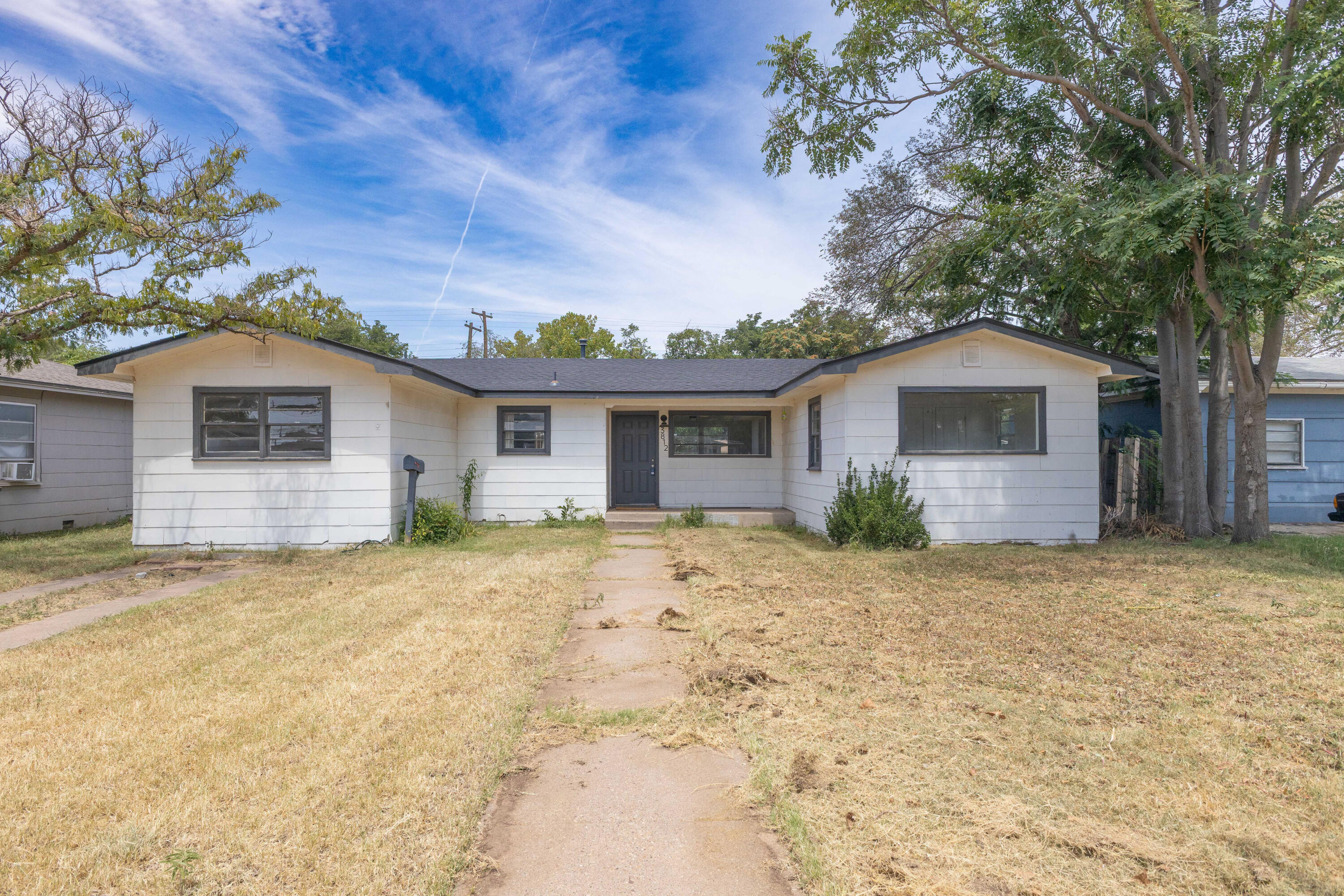3812 31st Street Lubbock, TX 79410 - Photo 2 of 16 a view of a house with a tree in front of it